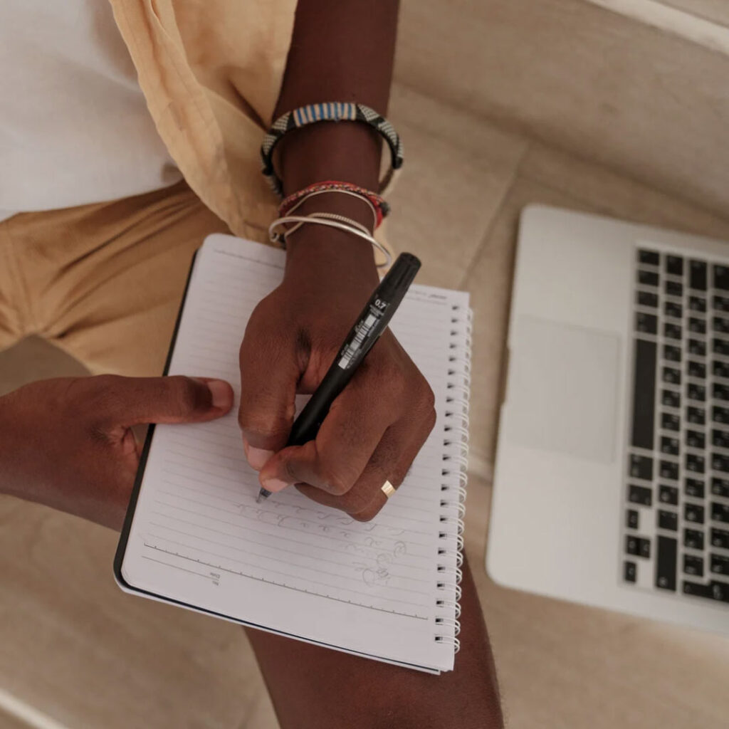 Person writing in notebook